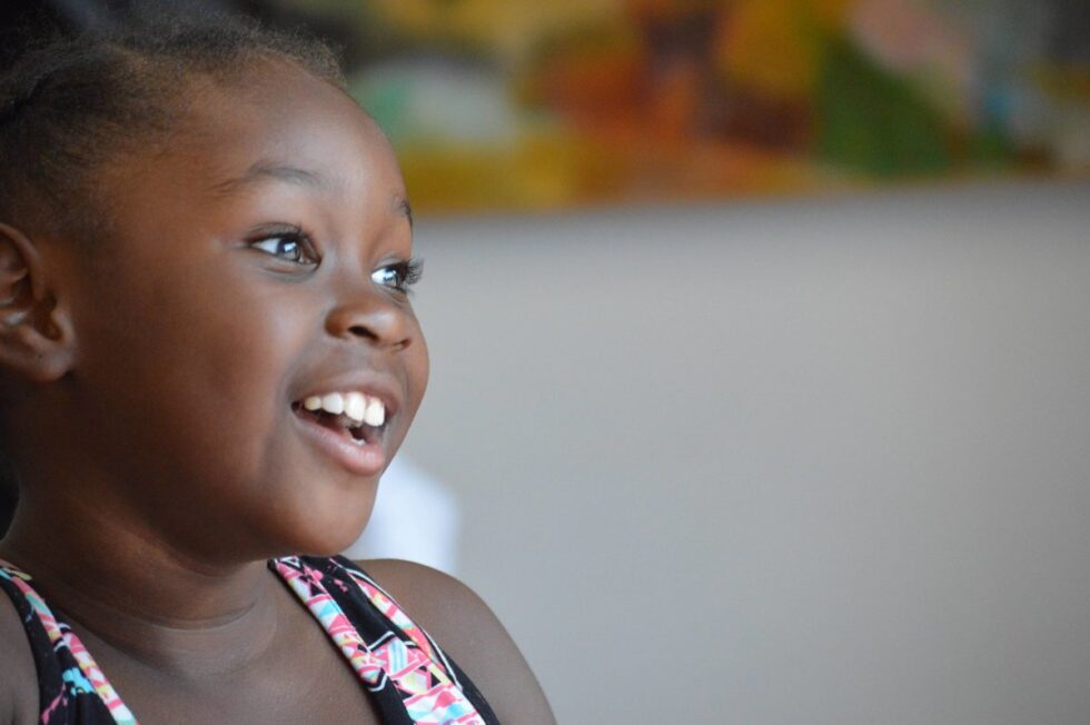 Young girl smiling and looking to the right