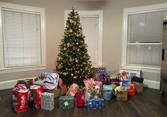Donations-under-holiday-tree-at-FamilyAid's-Brookline-family-shelter.