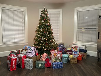 Donations-under-holiday-tree-at-FamilyAid's-Brookline-family-shelter.