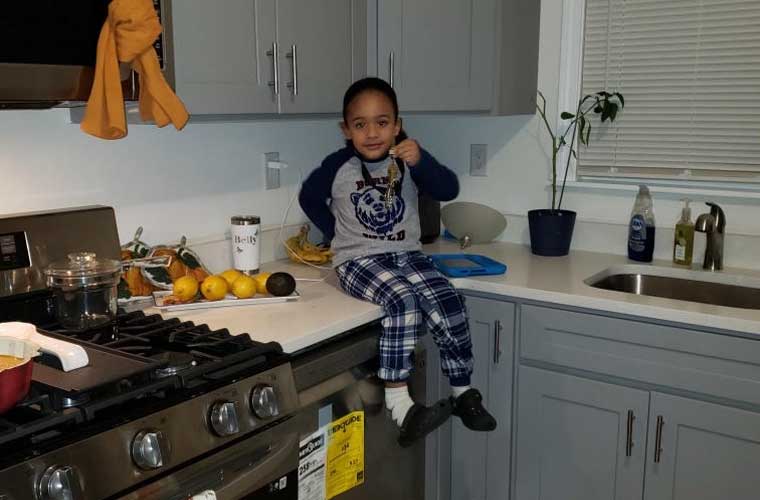 Young Boy Sitting on Kitchen Counter