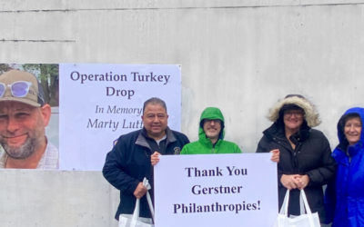 FamilyAid Staff in front of "Operation Turkey Drop" banner