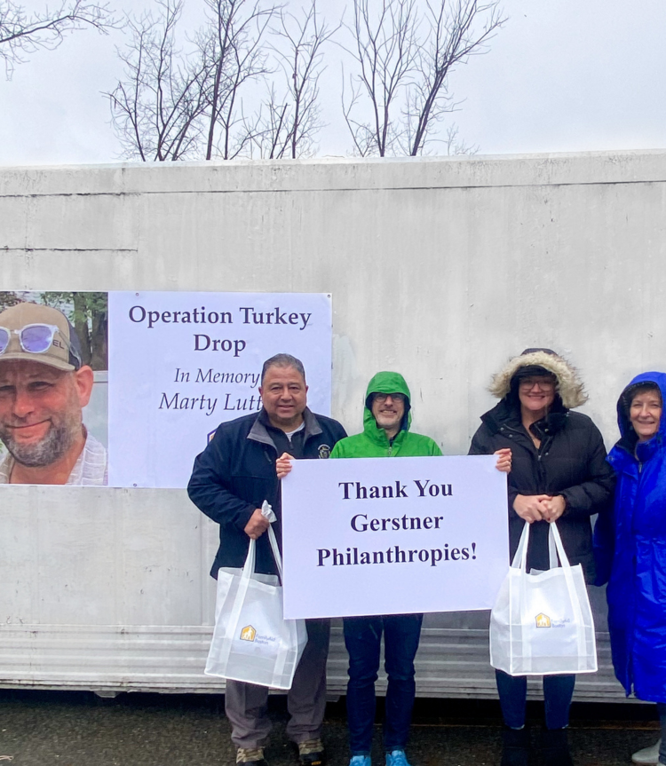 FamilyAid Staff in front of "Operation Turkey Drop" banner