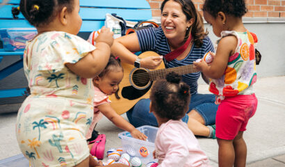 Children singing with musician