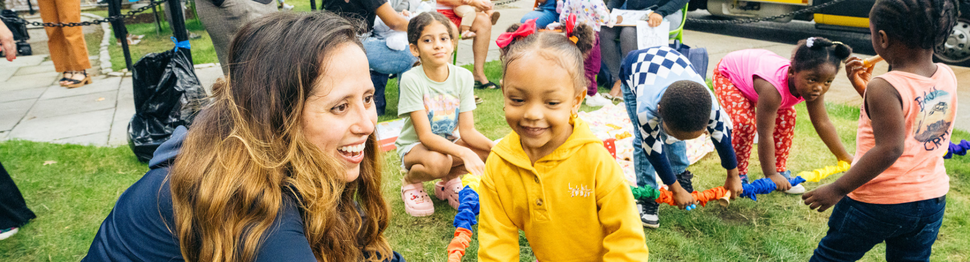 Young children smile and play together outside