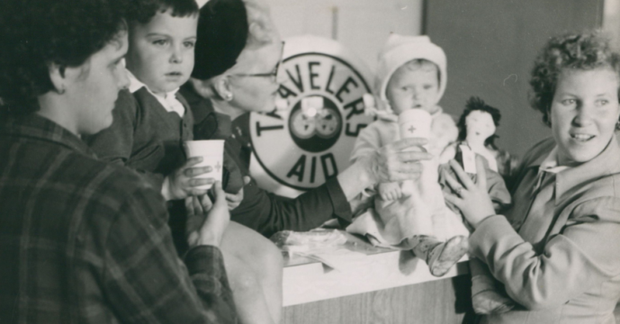 Traveler's Aid workers with family historic