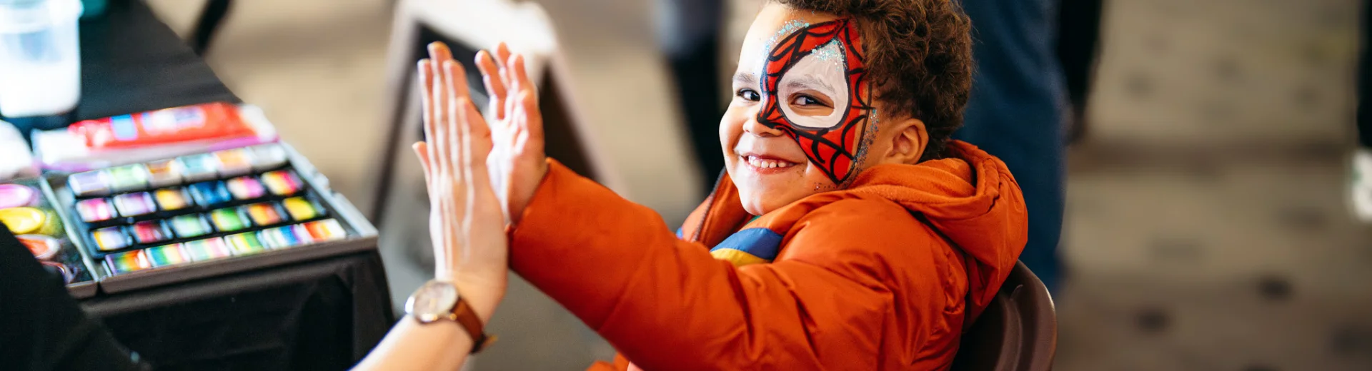 A smiling young boy at a FamilyAid activity