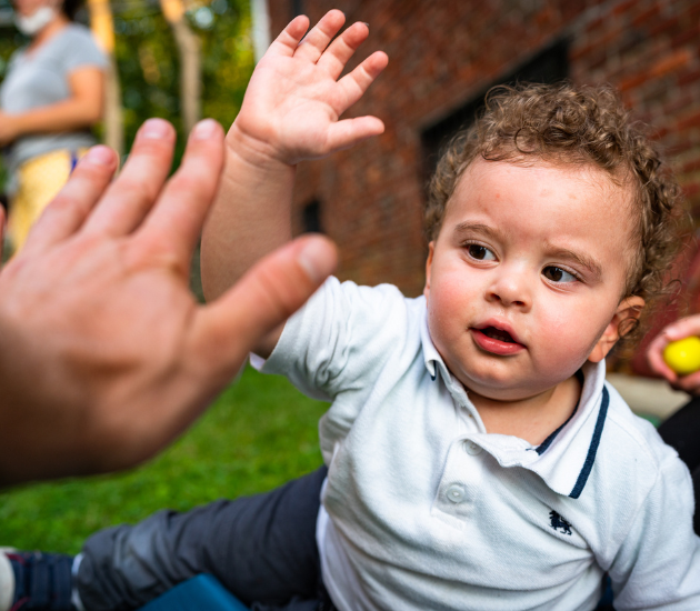 A young boy giving a high-five
